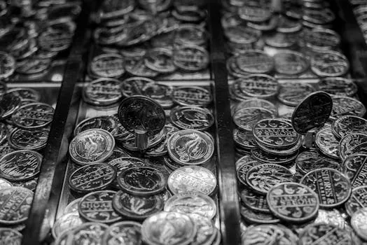 A detailed monochrome shot of coins, offering an aesthetic view of currency and abundance.